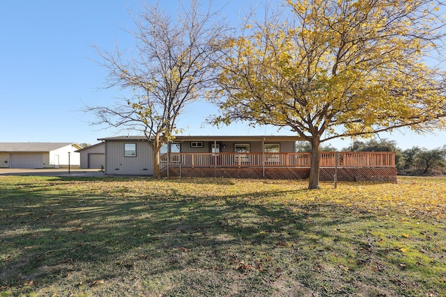 back of house with an outbuilding, a yard, and a garage