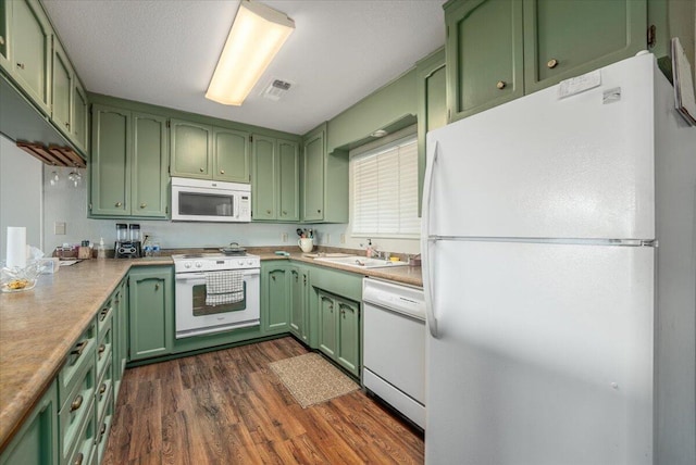 kitchen featuring dark hardwood / wood-style flooring, white appliances, green cabinets, and sink