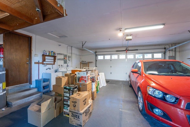 garage with washer and dryer and a garage door opener