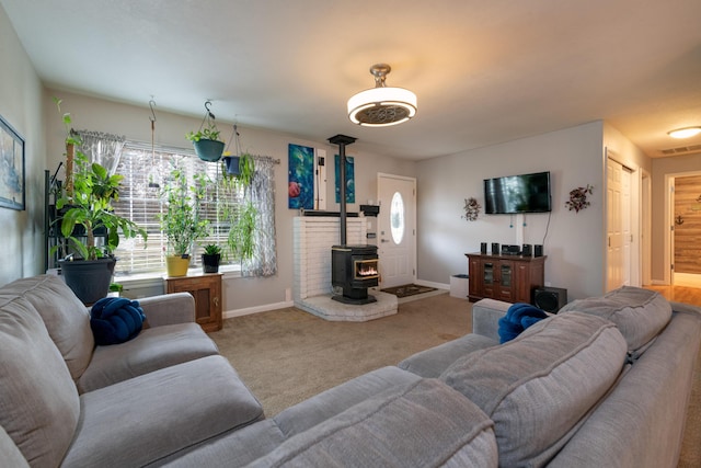 living room with a wood stove and carpet