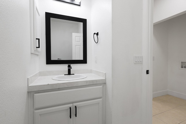 bathroom with tile patterned floors and vanity