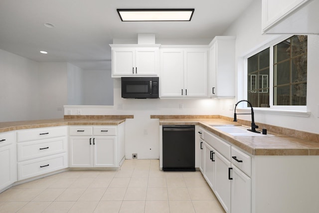 kitchen with tile countertops, black appliances, white cabinets, sink, and light tile patterned flooring