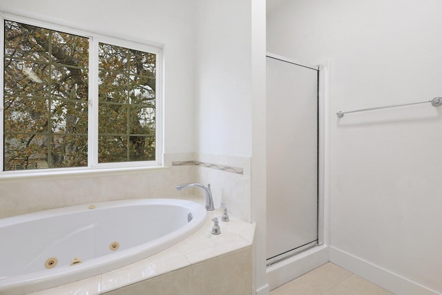 bathroom with tile patterned floors, plenty of natural light, and separate shower and tub