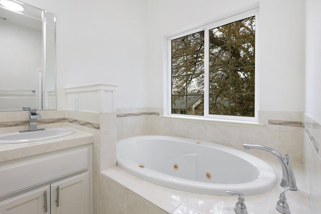 bathroom featuring vanity and tiled tub