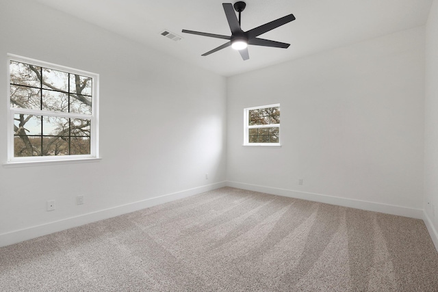 unfurnished room featuring ceiling fan, carpet floors, and a wealth of natural light