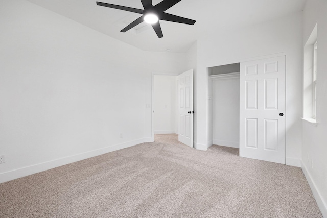 unfurnished bedroom featuring light carpet, a closet, and ceiling fan