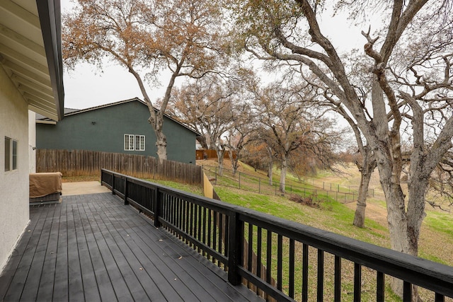 wooden deck featuring a lawn