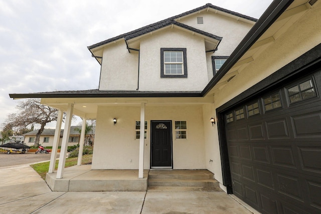 view of front facade featuring a garage and covered porch