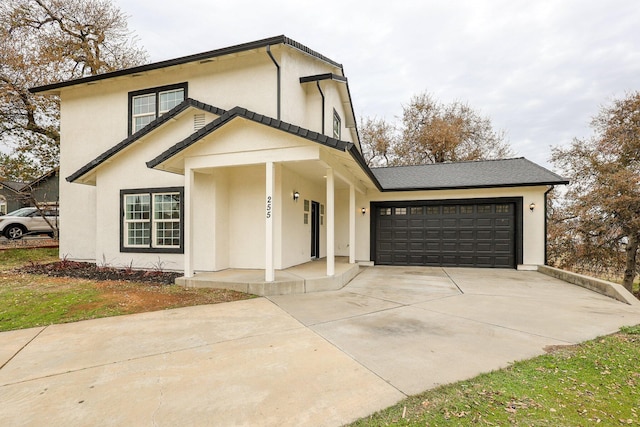 view of front of house featuring a porch and a garage