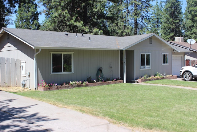 single story home featuring a garage, a front yard, and central AC