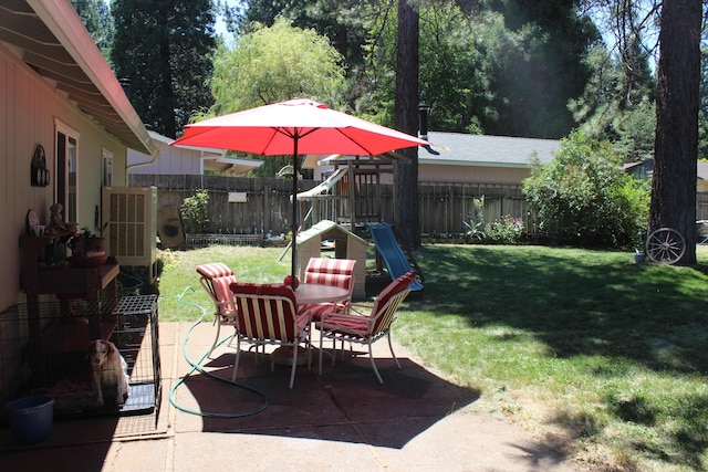 view of patio featuring a playground and central AC unit