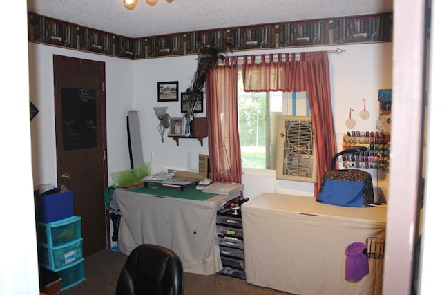 carpeted home office with a textured ceiling