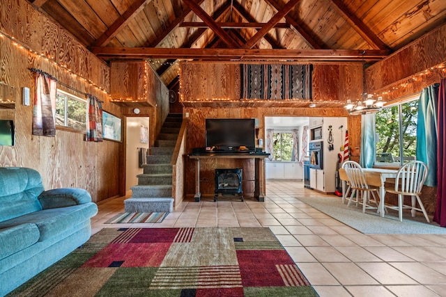 tiled living room with plenty of natural light, wood ceiling, and high vaulted ceiling