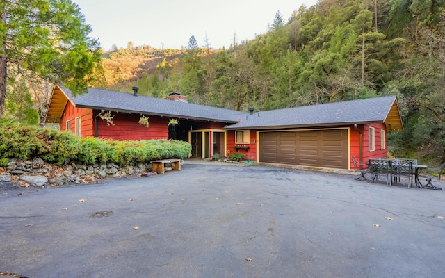 ranch-style home with a mountain view and a garage