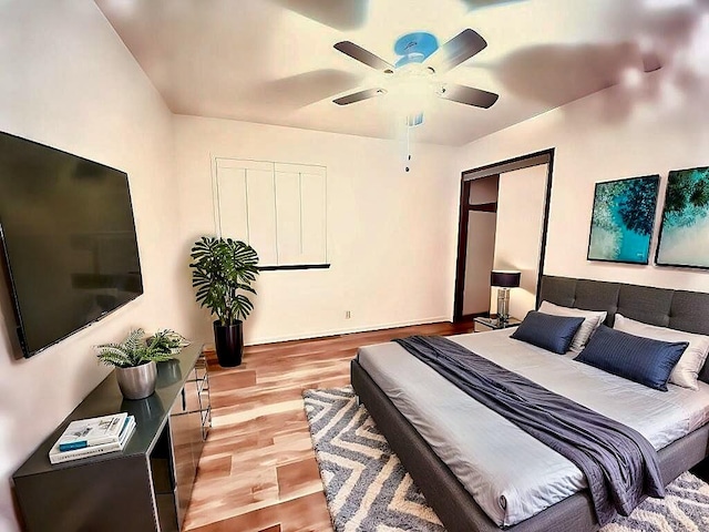 bedroom featuring light wood-type flooring, a closet, and ceiling fan