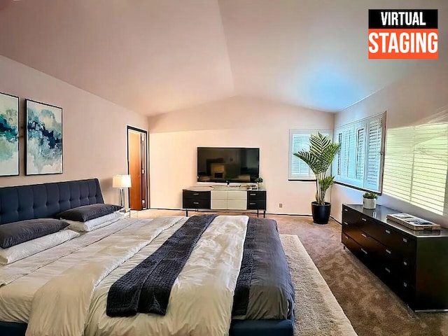 carpeted bedroom with lofted ceiling