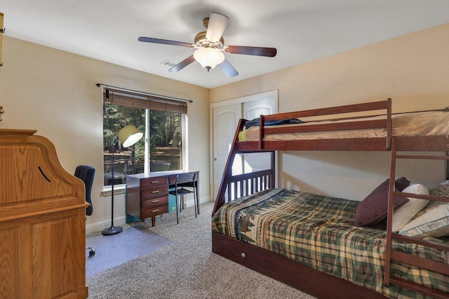 bedroom featuring ceiling fan, light colored carpet, and a closet