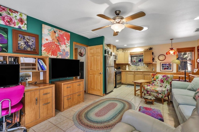 tiled living room with ceiling fan and sink