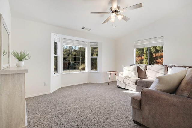 carpeted living room with vaulted ceiling and ceiling fan