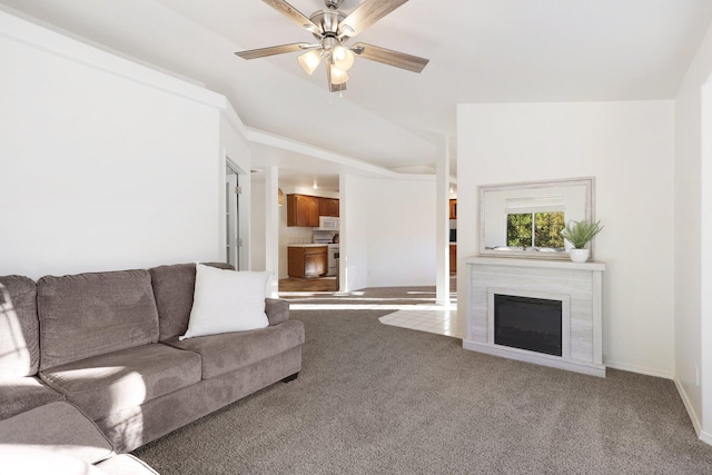 carpeted living room featuring ceiling fan and vaulted ceiling