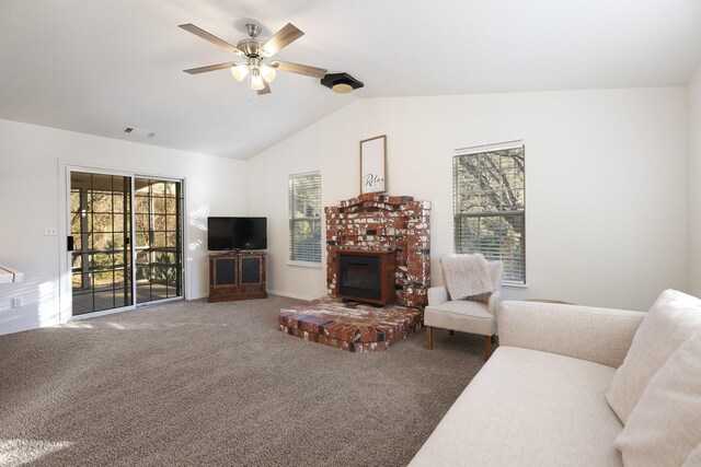 carpeted living room featuring a brick fireplace, ceiling fan, and vaulted ceiling