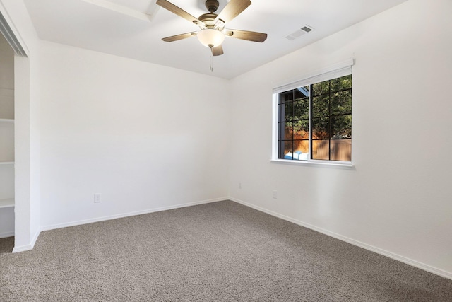 carpeted empty room featuring ceiling fan