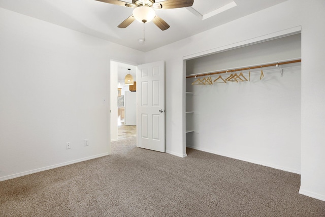 unfurnished bedroom featuring carpet, a closet, ceiling fan, and white fridge