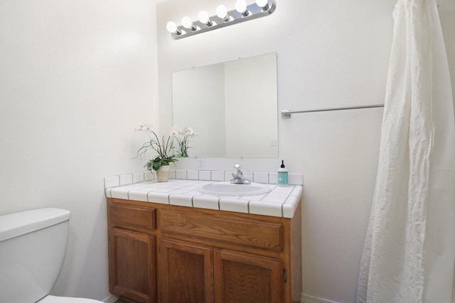 bathroom featuring vanity and toilet