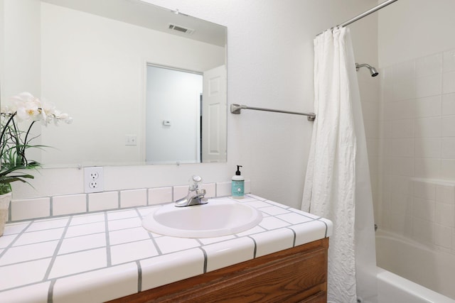 bathroom with vanity and shower / bathtub combination with curtain