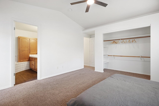 carpeted bedroom featuring ensuite bath, ceiling fan, a closet, and lofted ceiling