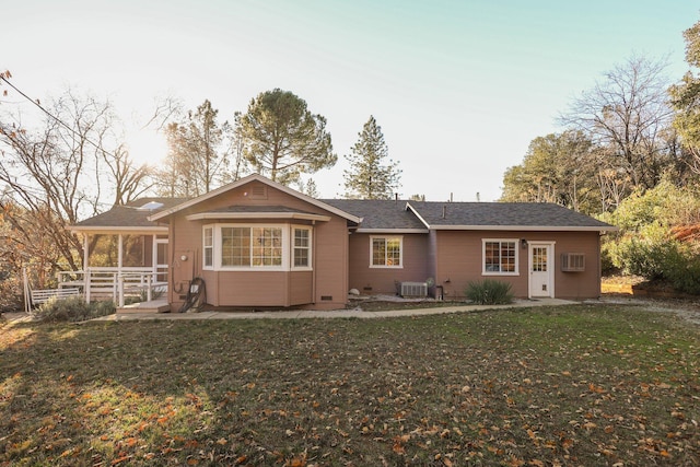 back of house with a lawn and central AC