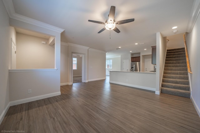 unfurnished living room featuring ceiling fan, dark hardwood / wood-style flooring, and crown molding