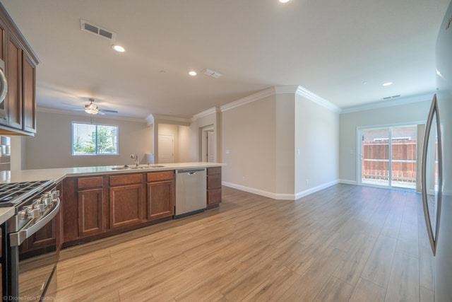 kitchen featuring a wealth of natural light, light hardwood / wood-style flooring, stainless steel appliances, and sink