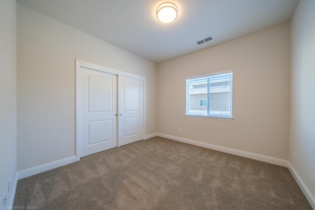 unfurnished bedroom with a closet and carpet