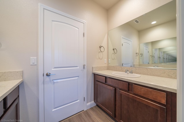 bathroom with vanity and wood-type flooring