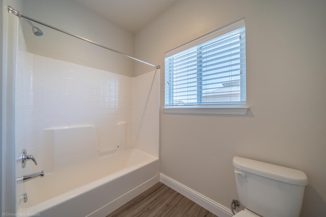 bathroom featuring wood-type flooring, toilet, and tub / shower combination