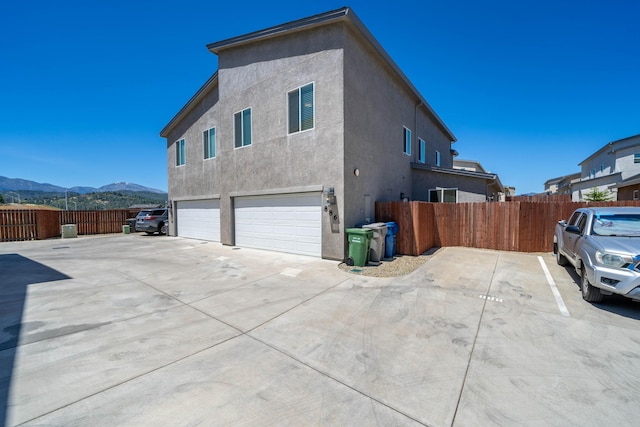 view of home's exterior featuring a mountain view and a garage