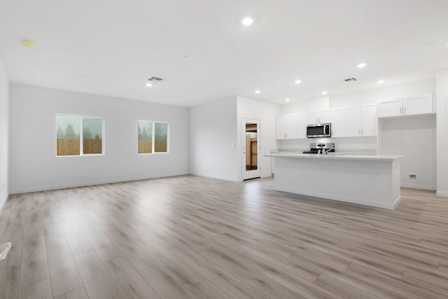 unfurnished living room featuring light hardwood / wood-style floors