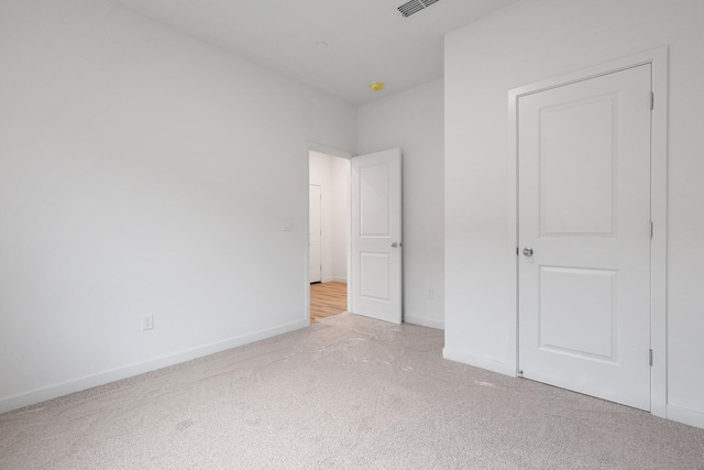 unfurnished bedroom featuring light carpet