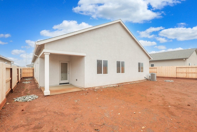 rear view of property featuring a patio and central AC