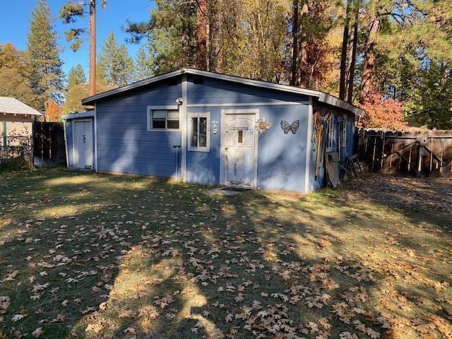 view of outbuilding with a yard