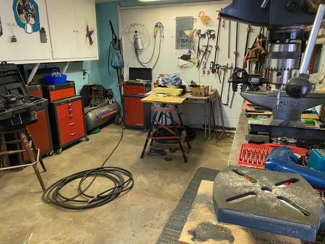 37412 Birch Ave, Burney, CA 96013 - miscellaneous room featuring a workshop area and concrete flooring