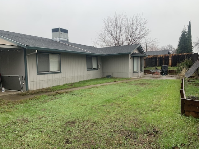 view of side of home with cooling unit and a lawn