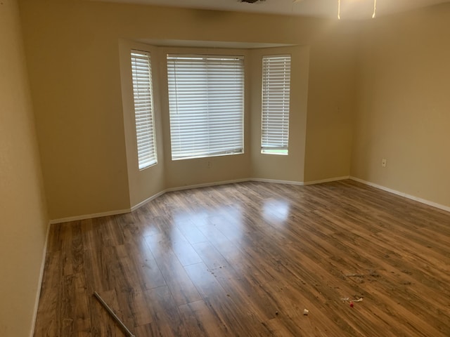 empty room with dark wood-type flooring