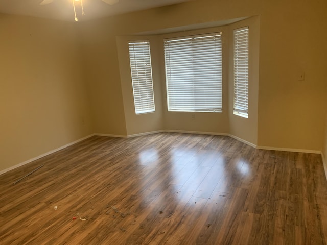 unfurnished room with hardwood / wood-style flooring and ceiling fan