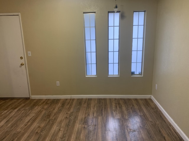 empty room with dark wood-type flooring