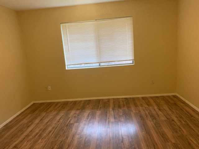 empty room with dark wood-type flooring