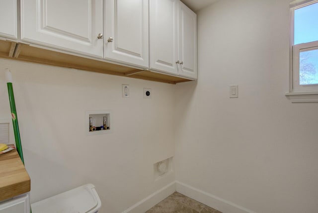 clothes washing area featuring hookup for a washing machine, light tile patterned floors, cabinets, and hookup for an electric dryer