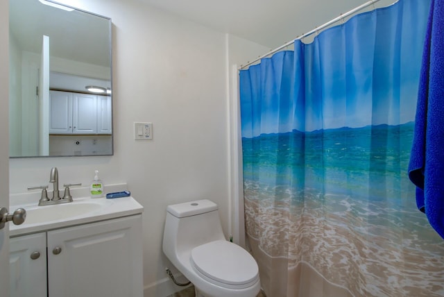 bathroom featuring vanity, toilet, and curtained shower