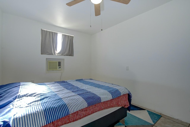 bedroom with a wall unit AC and ceiling fan